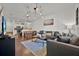 Open living area with gray sofa, wood floors, and unique lighting fixture at 3205 Gold Ln, Kissimmee, FL 34747