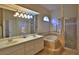 Elegant bathroom with double sinks, bathtub, and shower at 3555 Maribella Dr, New Smyrna Beach, FL 32168