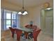 Casual breakfast nook with glass table and red leather chairs at 3555 Maribella Dr, New Smyrna Beach, FL 32168