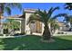 Beautiful one-story home with palm trees and well-manicured lawn at 3555 Maribella Dr, New Smyrna Beach, FL 32168