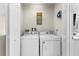 Bright laundry room with washer and dryer, and built-in shelving at 602 La Mirage St, Davenport, FL 33897