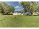 Spacious backyard with a grassy area and mature trees at 762 Toulon Dr, Kissimmee, FL 34759