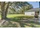 Large backyard with a fire pit and mature oak tree providing shade at 762 Toulon Dr, Kissimmee, FL 34759
