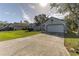 House exterior showcasing a two-car garage and well-maintained lawn at 762 Toulon Dr, Kissimmee, FL 34759