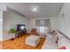 Bright living room featuring a sectional sofa and large window at 762 Toulon Dr, Kissimmee, FL 34759