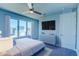 Bright bedroom with a large TV and ample closet space at 7760 Sandy Ridge Dr # 222, Kissimmee, FL 34747