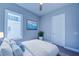 Bedroom with a queen bed and light blue walls at 7760 Sandy Ridge Dr # 222, Kissimmee, FL 34747