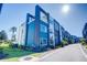 Modern townhome community with blue and white exterior, and a paved walkway at 7760 Sandy Ridge Dr # 222, Kissimmee, FL 34747