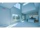Open concept living area with high ceilings, kitchen island, and large windows at 7760 Sandy Ridge Dr # 222, Kissimmee, FL 34747