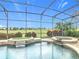 Enclosed pool and hot tub area with golf course view at 8914 Dove Valley Way, Davenport, FL 33896
