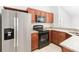 Modern kitchen with stainless steel appliances and wood cabinets at 9808 Flynt Cir, Orlando, FL 32825