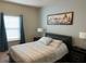 Serene bedroom with a comfortable bed and large window at 9004 Shine Dr, Kissimmee, FL 34747