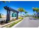 Entrance to West Lakes community featuring a welcoming sign and landscaping at 9004 Shine Dr, Kissimmee, FL 34747