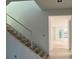 Modern staircase with white walls and wood steps at 13050 Sunrise Harvest Dr, Winter Garden, FL 34787