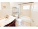 Bathroom with tub, toilet, and vanity with shelving at 1403 Amaros Ave, Orlando, FL 32811
