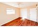 Well-lit bedroom with wood-looking floors and double closet at 1403 Amaros Ave, Orlando, FL 32811