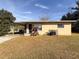 Ranch-style home with carport and mature landscaping at 1403 Amaros Ave, Orlando, FL 32811