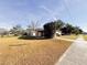 Tan single story house with sidewalk and grassy yard at 1403 Amaros Ave, Orlando, FL 32811