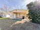 Tan single story house with covered patio and grassy yard at 1403 Amaros Ave, Orlando, FL 32811