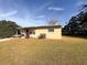 Tan block home with a spacious yard and driveway at 1403 Amaros Ave, Orlando, FL 32811