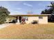 Ranch-style home with carport and mature landscaping at 1403 Amaros Ave, Orlando, FL 32811