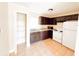 Kitchen with dark cabinets, granite counters, and white appliances at 1403 Amaros Ave, Orlando, FL 32811