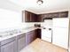 Kitchen with dark cabinets, granite counters, and white appliances at 1403 Amaros Ave, Orlando, FL 32811