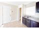 Kitchen with dark cabinets, granite counters, and pantry at 1403 Amaros Ave, Orlando, FL 32811
