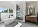 Spa-like bathroom with a freestanding tub, walk-in shower, and dual vanities at 1606 Hart Ln, Orlando, FL 32804