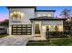 Stunning two-story home with a modern design, featuring a metal roof and landscaped front yard at 1606 Hart Ln, Orlando, FL 32804