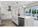 Bright kitchen with white cabinets, quartz countertops, and a farmhouse sink at 1606 Hart Ln, Orlando, FL 32804
