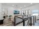 Open loft area with wood flooring and a modern cable railing at 1606 Hart Ln, Orlando, FL 32804