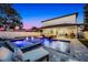 Luminous pool at night with built in spa and fire pit at 1606 Hart Ln, Orlando, FL 32804