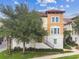 Three-story townhome with stucco exterior and tile roof at 1801 Lobelia Dr, Lake Mary, FL 32746