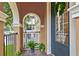 Small front balcony with arched entryway and iron railing at 1801 Lobelia Dr, Lake Mary, FL 32746