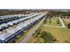 Aerial view of houses, road, and green areas in a community at 2477 Shanti Dr, Kissimmee, FL 34746
