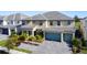 Two-story house with a two-car garage and landscaped yard at 2477 Shanti Dr, Kissimmee, FL 34746