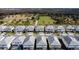 Aerial view of community with houses and pools by a lake at 2477 Shanti Dr, Kissimmee, FL 34746