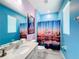 Disney themed bathroom with shower and light blue walls at 2477 Shanti Dr, Kissimmee, FL 34746