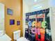 Retro game-themed bathroom with shower and decor at 2477 Shanti Dr, Kissimmee, FL 34746