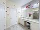 Mickey Mouse themed bathroom with double vanity and large mirror at 2477 Shanti Dr, Kissimmee, FL 34746