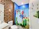 Super Mario themed bathroom with shower and brick-patterned walls at 2477 Shanti Dr, Kissimmee, FL 34746
