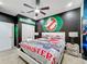 Ghostbusters themed bedroom with king-size bed and wall art at 2477 Shanti Dr, Kissimmee, FL 34746
