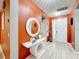 Bright entry with orange walls and modern console table at 2477 Shanti Dr, Kissimmee, FL 34746