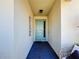 Inviting entryway with teal door and tile flooring at 2477 Shanti Dr, Kissimmee, FL 34746