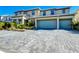 Two-story house with two-car garage and landscaped front yard at 2477 Shanti Dr, Kissimmee, FL 34746