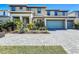 Two-story house with two-car garage and landscaped front yard at 2477 Shanti Dr, Kissimmee, FL 34746