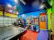 Vibrant game room with pool table, arcade games, and a claw machine at 2477 Shanti Dr, Kissimmee, FL 34746