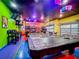 Playful game room, complete with air hockey, pool table, and seating at 2477 Shanti Dr, Kissimmee, FL 34746