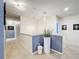 Upstairs hallway with neutral colors and modern light fixtures at 2477 Shanti Dr, Kissimmee, FL 34746